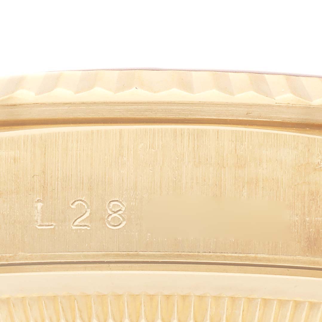 The image shows the side view of a Rolex President 18238 Men's Yellow Gold Champagne Dial 18238 Men's Yellow Gold Champagne Dial watch, highlighting the engraved serial numbers on its gold case.