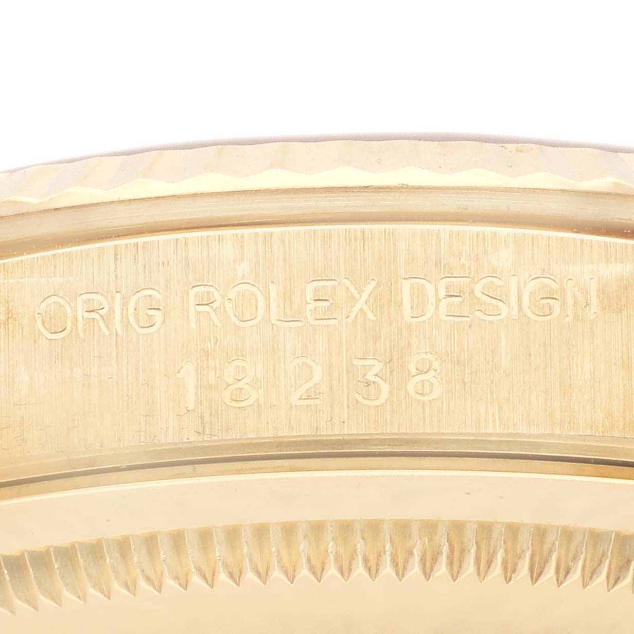 The image shows a close-up of the side engraving of a Rolex President 18238 Men's Yellow Gold Champagne Dial 18238 Men's Yellow Gold Champagne Dial model, displaying "ORIG ROLEX DESIGN" and the model number.