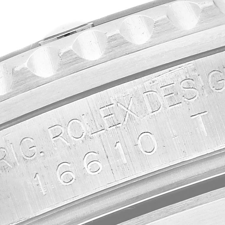 The image shows a close-up of the engraved inner bezel of a Rolex Submariner 16610 Men
s Stainless Steel Black Dial 16610 Men
s Stainless Steel Black Dial model.