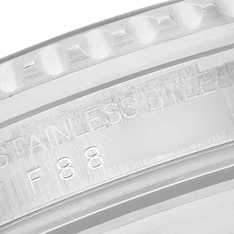 This image shows a close-up of the Rolex Submariner 16610 Men
s Stainless Steel Black Dial 16610 Men
s Stainless Steel Black Dial
s stainless steel case with engraved text.