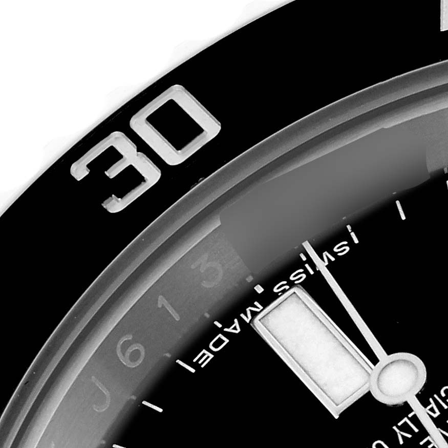 The image shows a close-up of the bezel and dial of a Rolex Submariner 114060 Men
s Stainless Steel Black Dial, highlighting the "30" marker and part of the watch face.