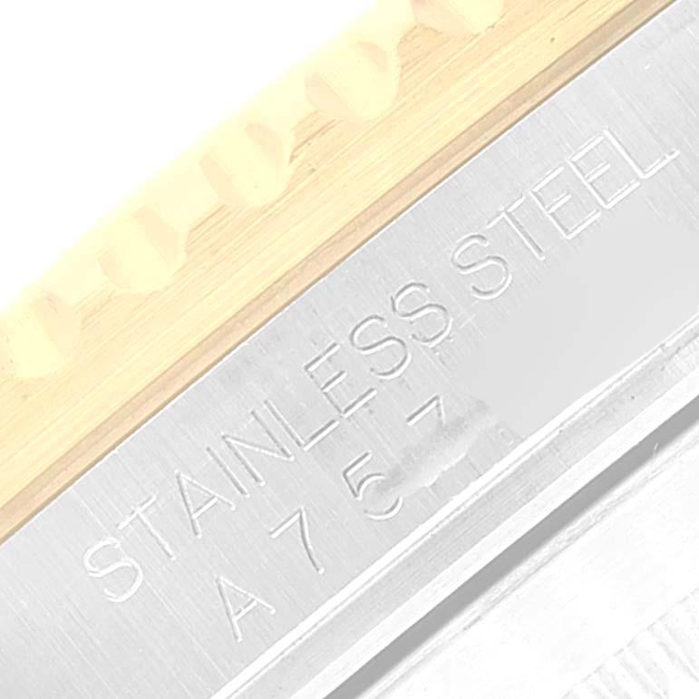 This close-up image shows the metal band engraved with "STAINLESS STEEL" on a Rolex Submariner 16613 Men's Steel and Gold (two tone) Black Dial 16613 Men's Steel and Gold (two tone) Black Dial watch.