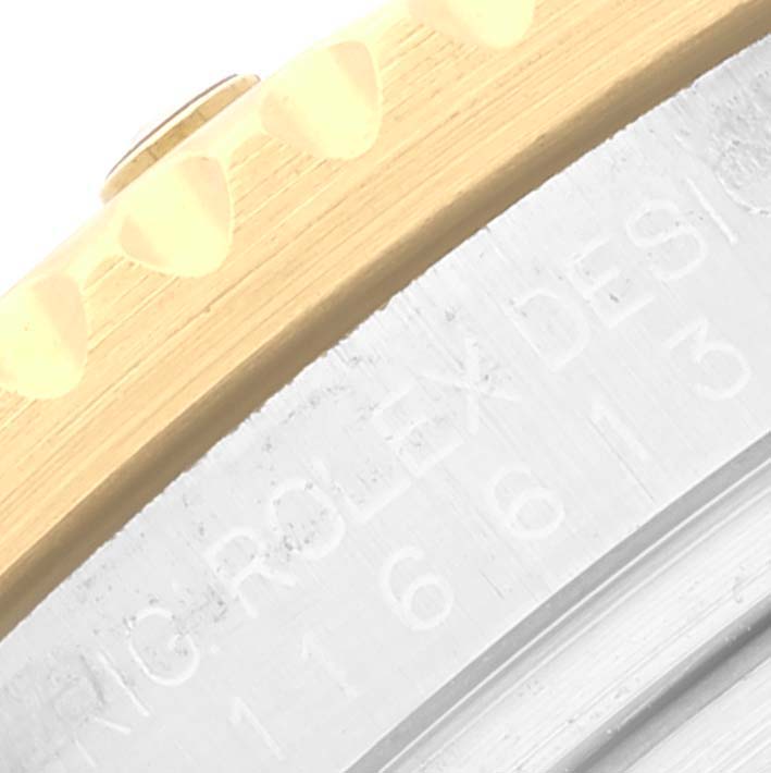 The image shows a close-up angle of the side case and bezel edge of a Rolex Submariner 116613 Men's Steel and Gold (two tone) Blue Dial 116613 Men's Steel and Gold (two tone) Blue Dial watch.