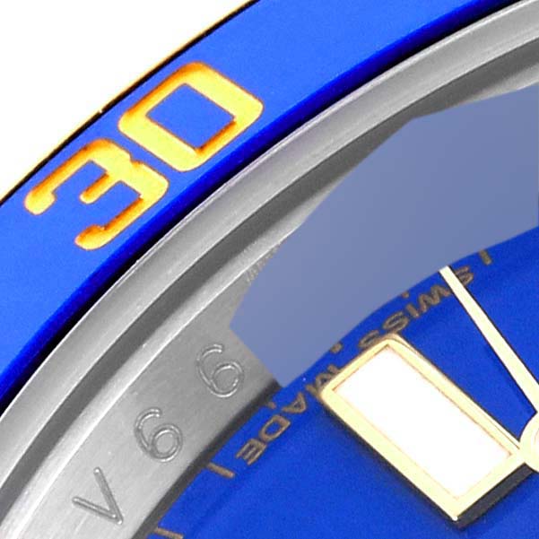 Close-up of the bezel and part of the dial of a blue Rolex Submariner 116613 Men's Steel and Gold (two tone) Blue Dial 116613 Men's Steel and Gold (two tone) Blue Dial, showing the number "30" and part of an hour marker.