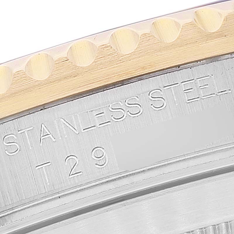 This close-up image shows the stainless steel case back and part of the gold bezel of a Rolex Submariner 16613 Men's Steel and Gold (two tone) Blue Dial 16613 Men's Steel and Gold (two tone) Blue Dial watch.