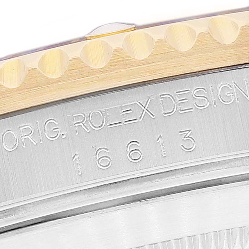 The image shows a close-up of the case side engraving and bezel of a Rolex Submariner 16613 Men's Steel and Gold (two tone) Blue Dial 16613 Men's Steel and Gold (two tone) Blue Dial watch, model 16613.