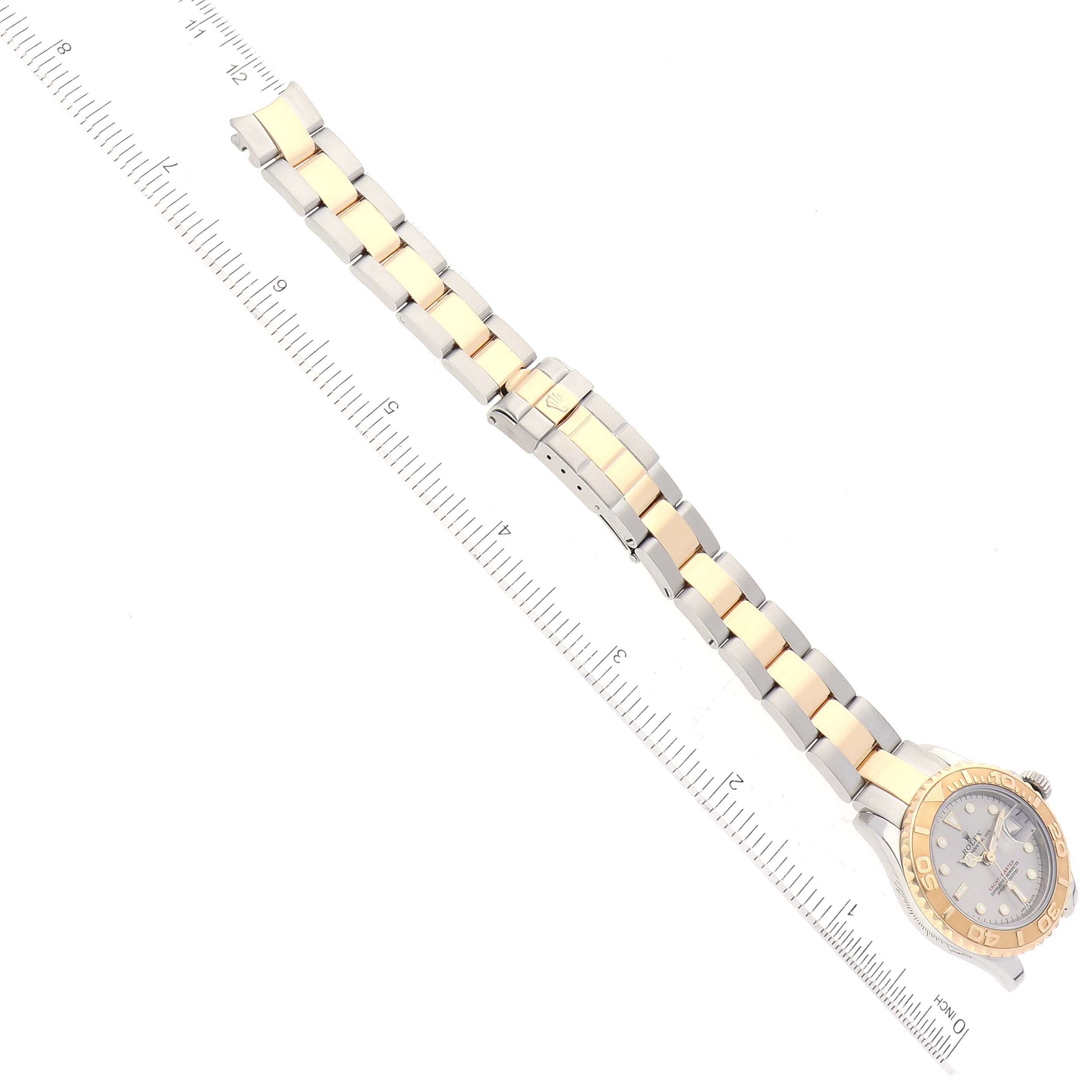 This image shows a top-down view of a Rolex Yacht-Master 169623 Women's Steel and Gold (two tone) Grey Dial 169623 Women's Steel and Gold (two tone) Grey Dial watch, with a measuring ruler beside it.