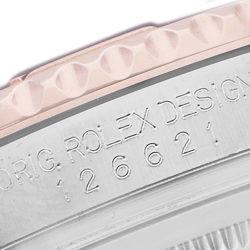 The close-up shows the side of the Rolex Yacht-Master 126621 Men's Steel and Gold (two tone) Black Dial's case, highlighting the engraved model number and bezel edge.