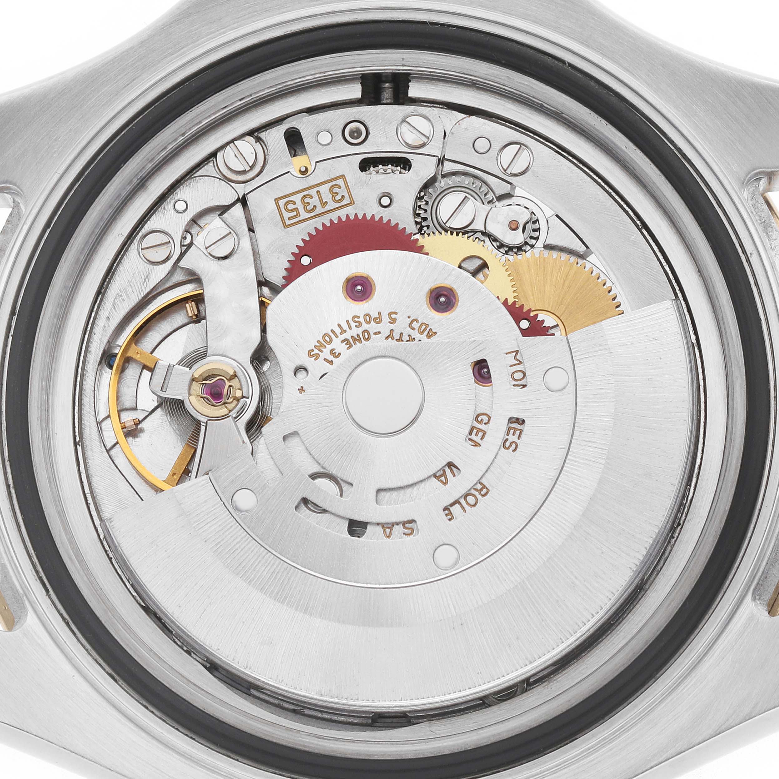 The image shows the Rolex Yacht-Master 16623 Men
s Steel and Gold (two tone) Champagne Dial
s movement from a back angle, highlighting gears and mechanical components.