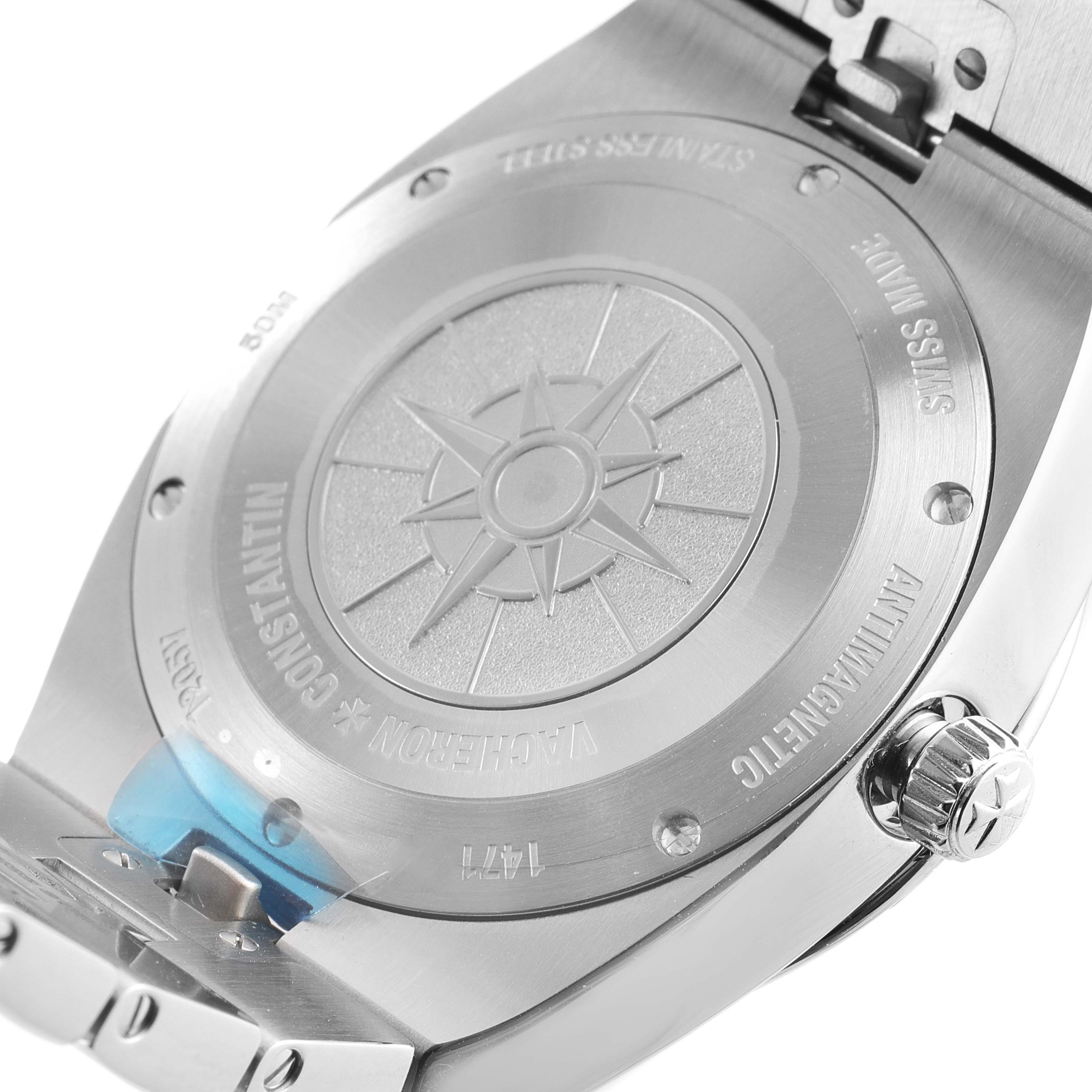 The image shows the case back and crown of a Vacheron Constantin Overseas 1205V/100A-B590 Women's Stainless Steel Blue Dial watch from a close-up angle, highlighting the engraved details.