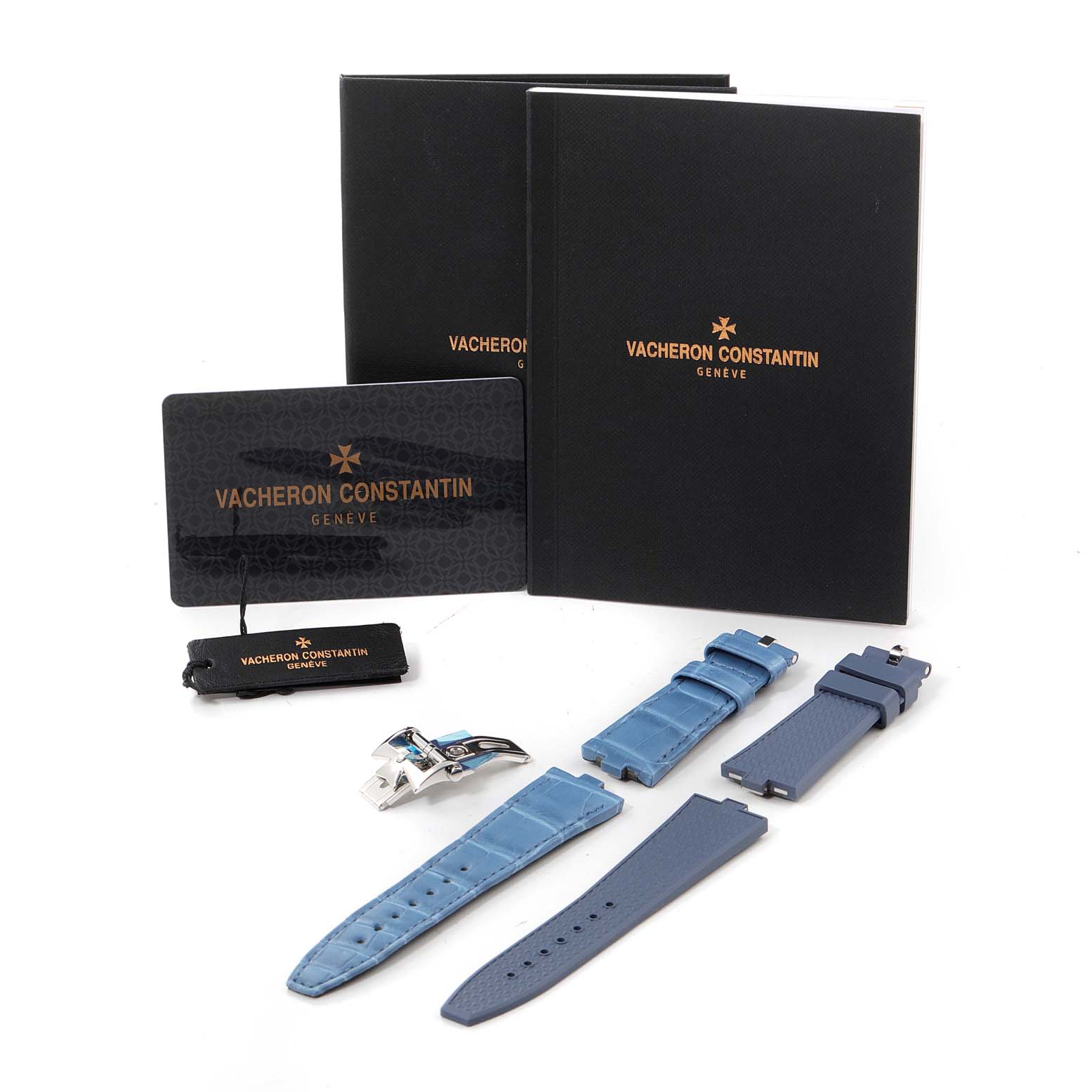 The image shows Vacheron Constantin Overseas 1205V/100A-B590 Women's Stainless Steel Blue Dial watch accessories, including straps, a clasp, and documentation, laid out from a top-down angle.