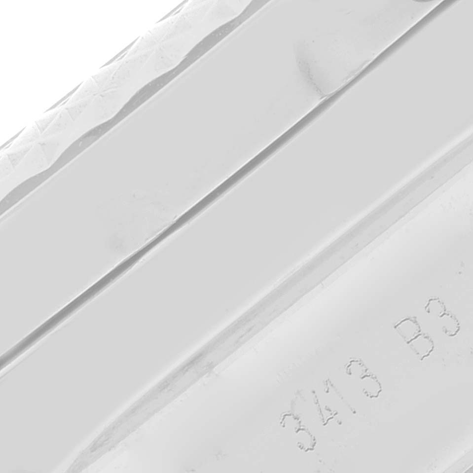 This close-up image of the Breitling Bentley AB0611 Men's Stainless Steel Silver Dial AB0611 Men's Stainless Steel Silver Dial watch shows a portion of the bezel and part of the case with engraved markings.