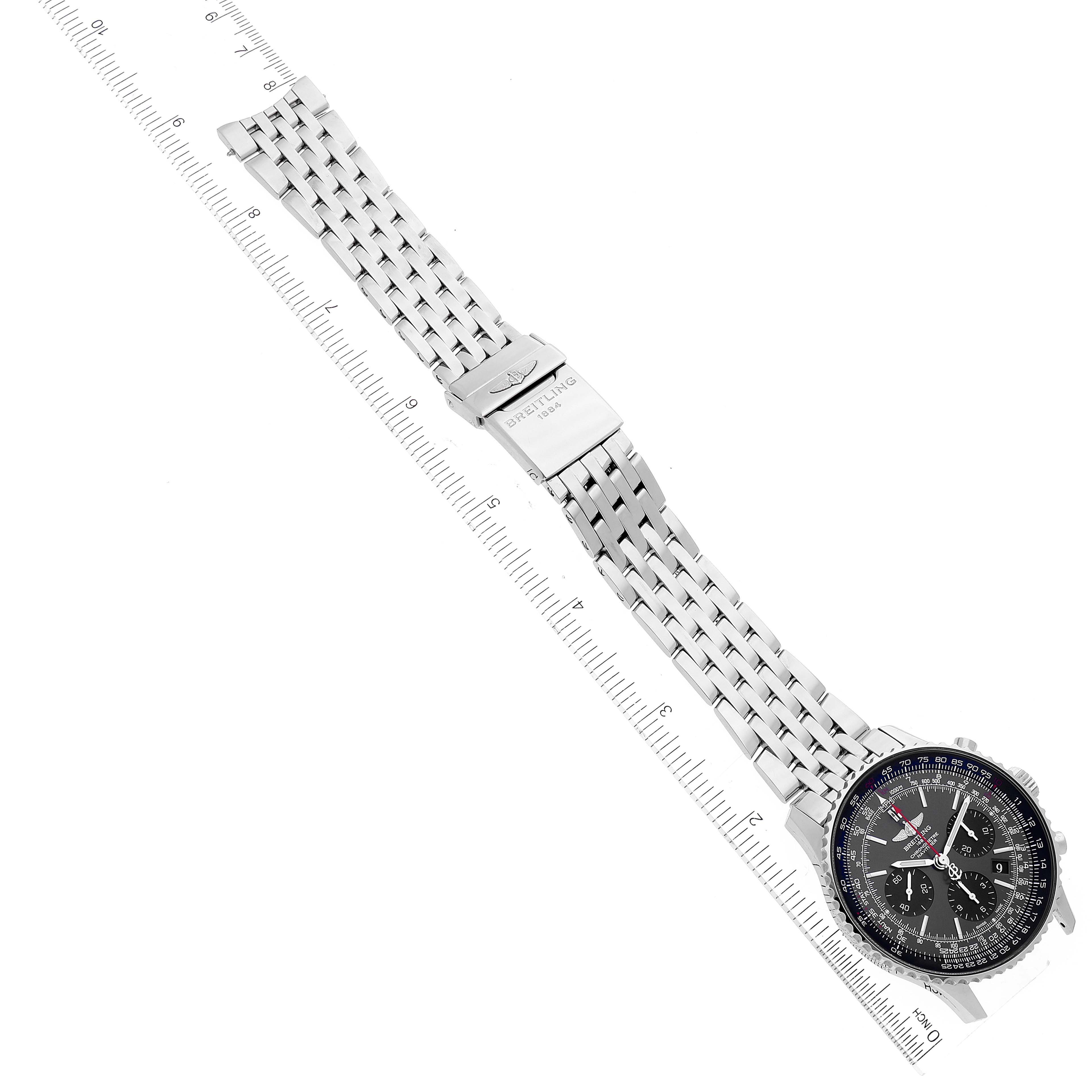 The image shows the Breitling Navitimer AB0121 Men's Stainless Steel Grey Dial AB0121 Men's Stainless Steel Grey Dial watch lying flat, with a full view of its face, band, and clasp alongside a ruler.