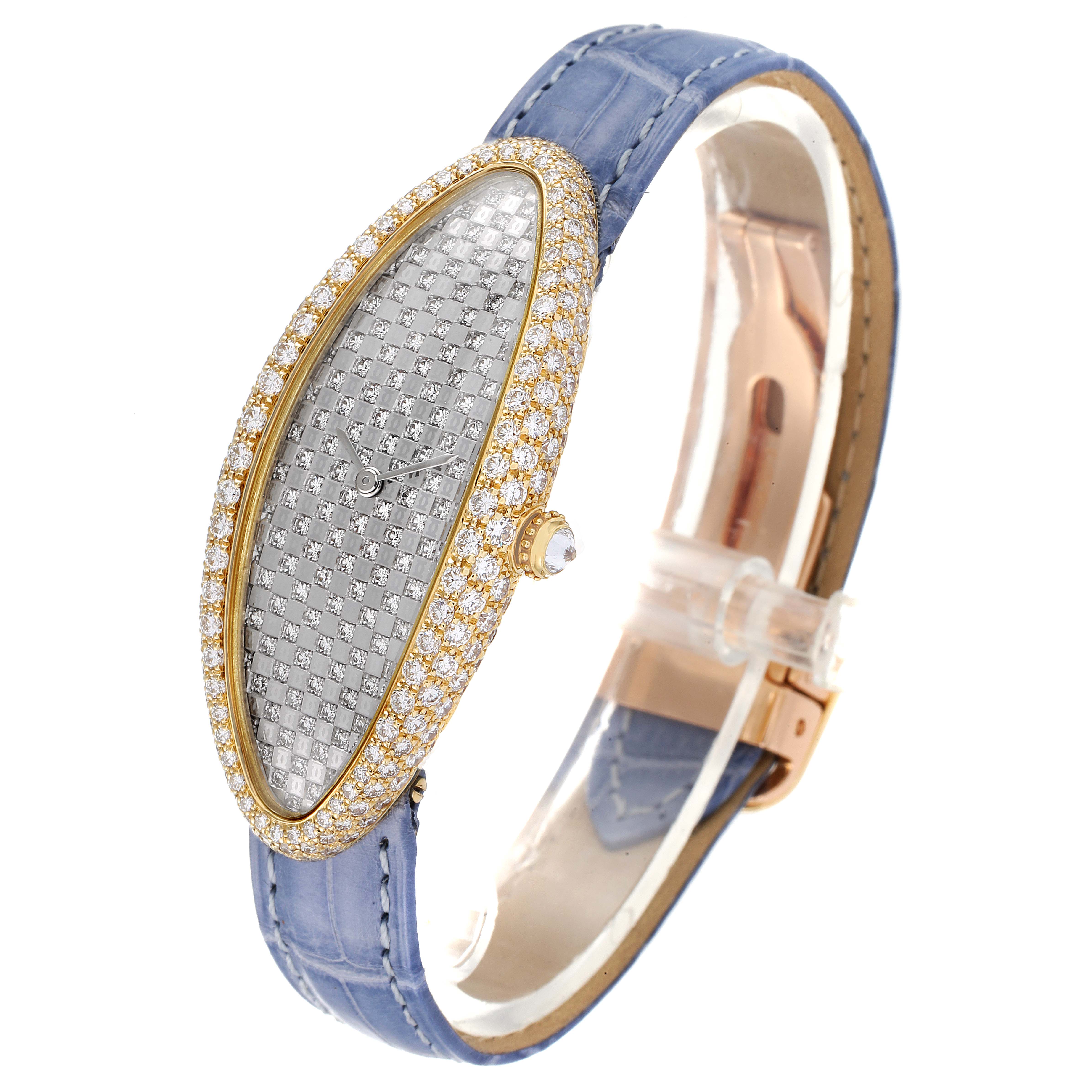 The Cartier Baignoire 2583 Women's Yellow Gold Silver Dial 2583 Women's Yellow Gold Silver Dial model watch is shown at an angle, displaying its oval face with diamond embellishments and blue strap.