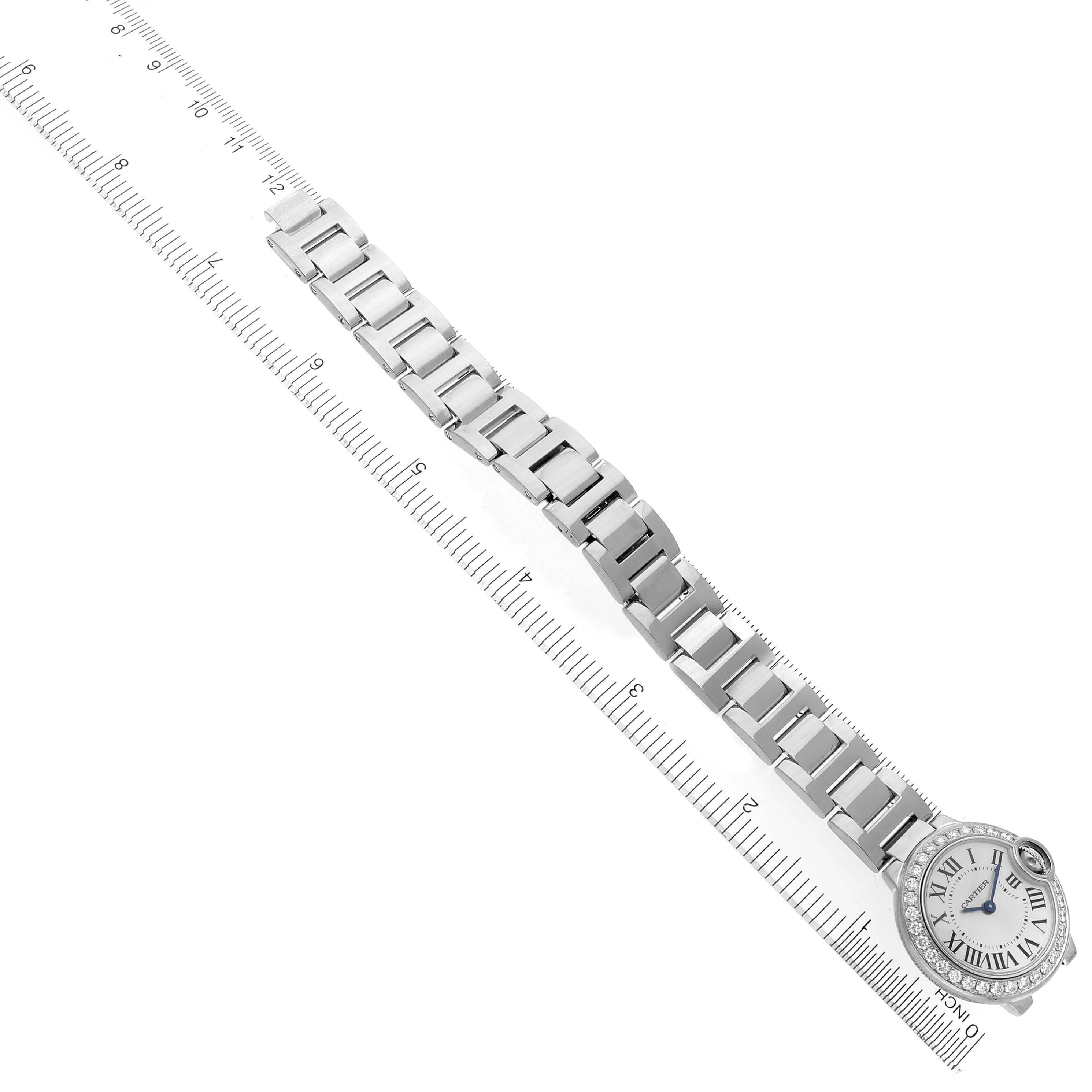 The Cartier Ballon Bleu WE9003Z3 Women
s White Gold Silver Dial WE9003Z3 Women
s White Gold Silver Dial watch is shown from a top view with its bracelet extended along a ruler.