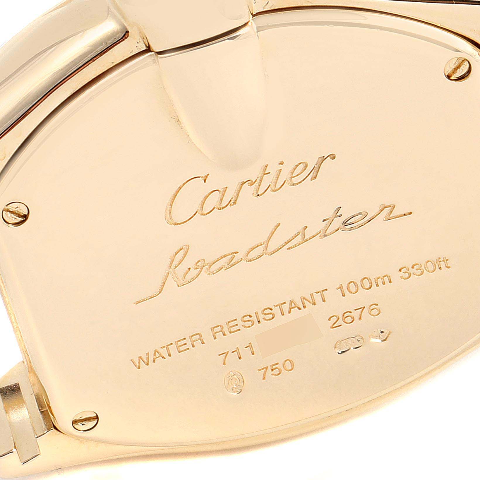 This image shows the close-up of the back cover of the Cartier Roadster WE5001X1 Women's Yellow Gold Silver Dial WE5001X1 Women's Yellow Gold Silver Dial watch, highlighting its engravings and screws.