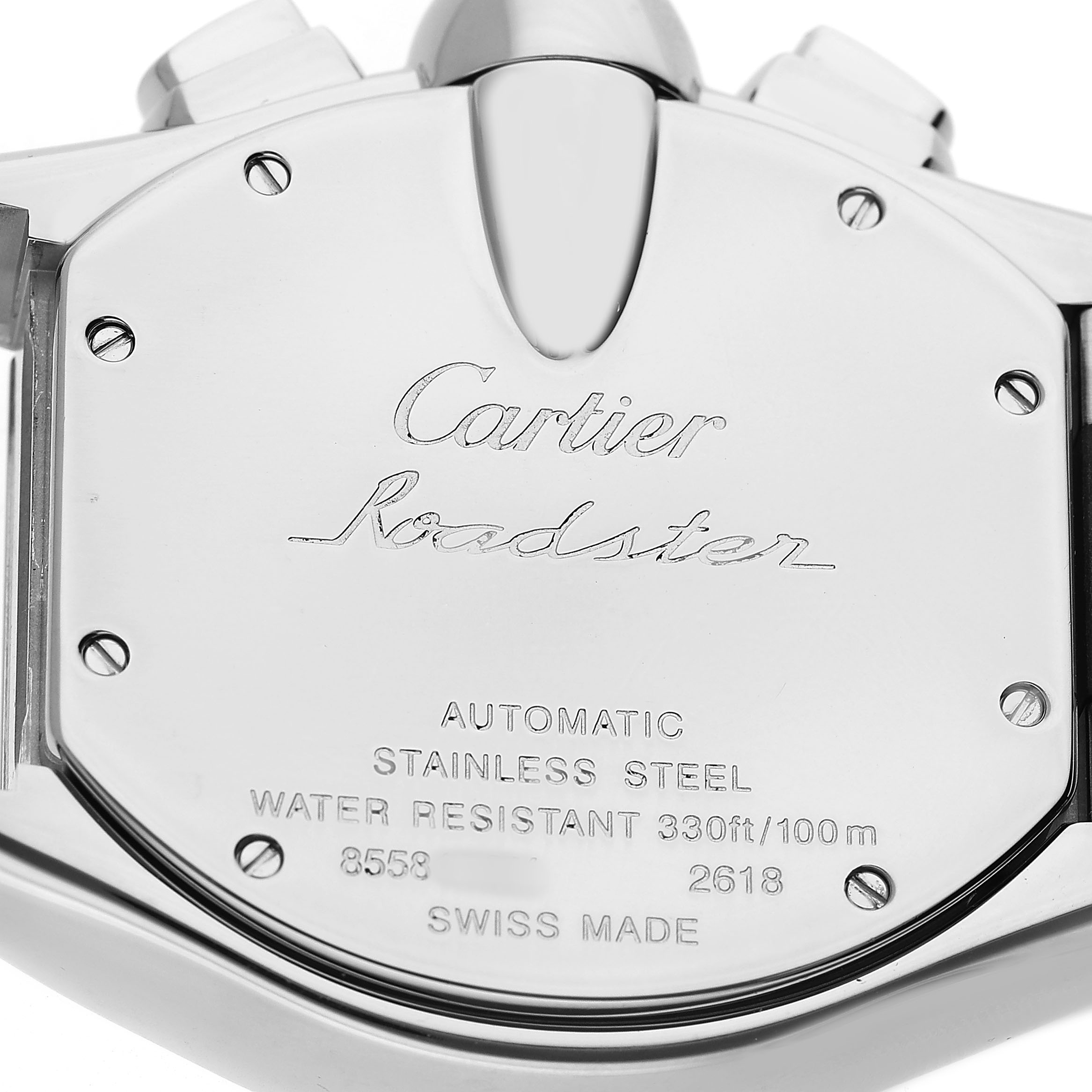 The image shows the back case of a Cartier Roadster W62019X6 Men's Stainless Steel Silver Dial watch, featuring engravings and screws.