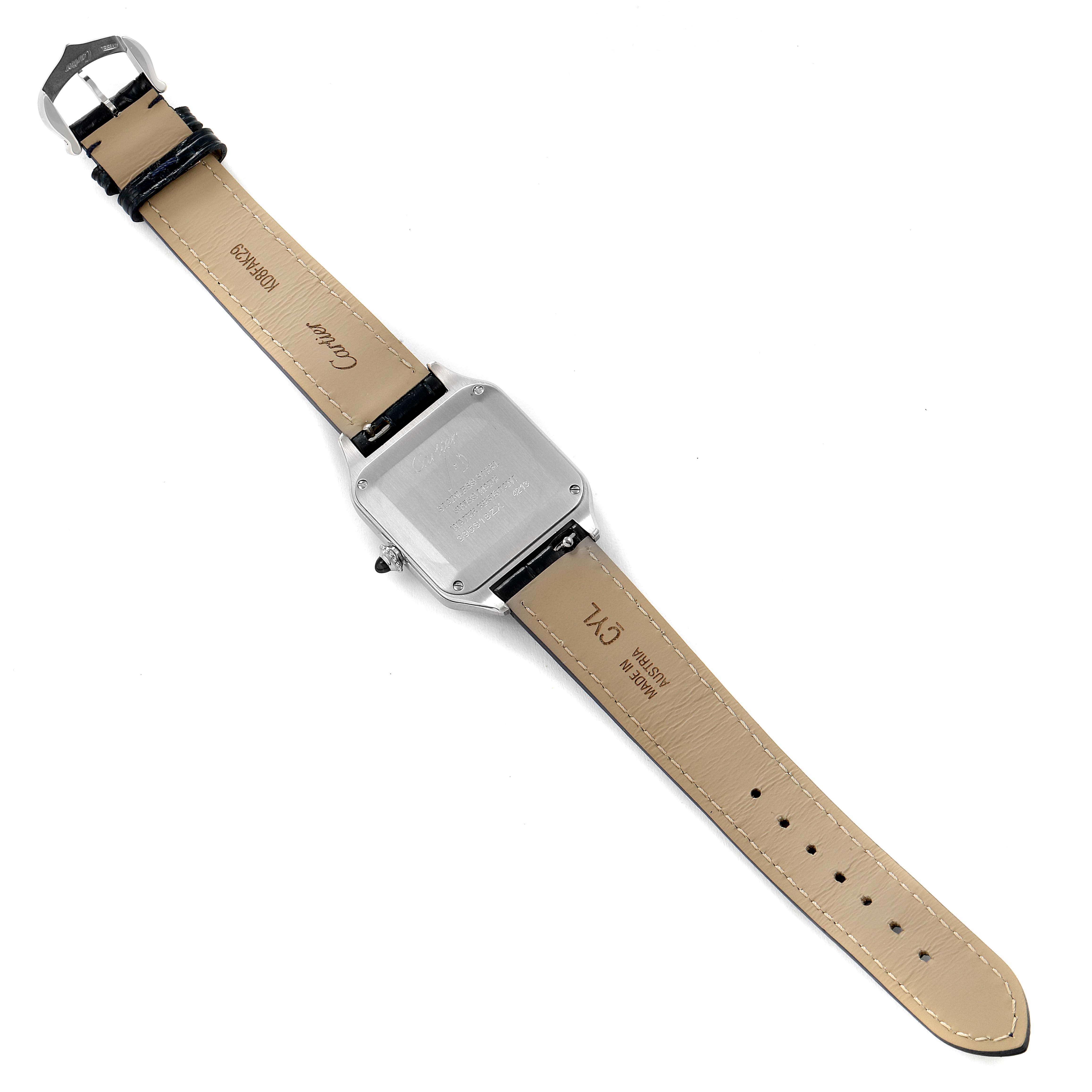 The image shows the backside and strap of a Santos model watch by Cartier laid flat.