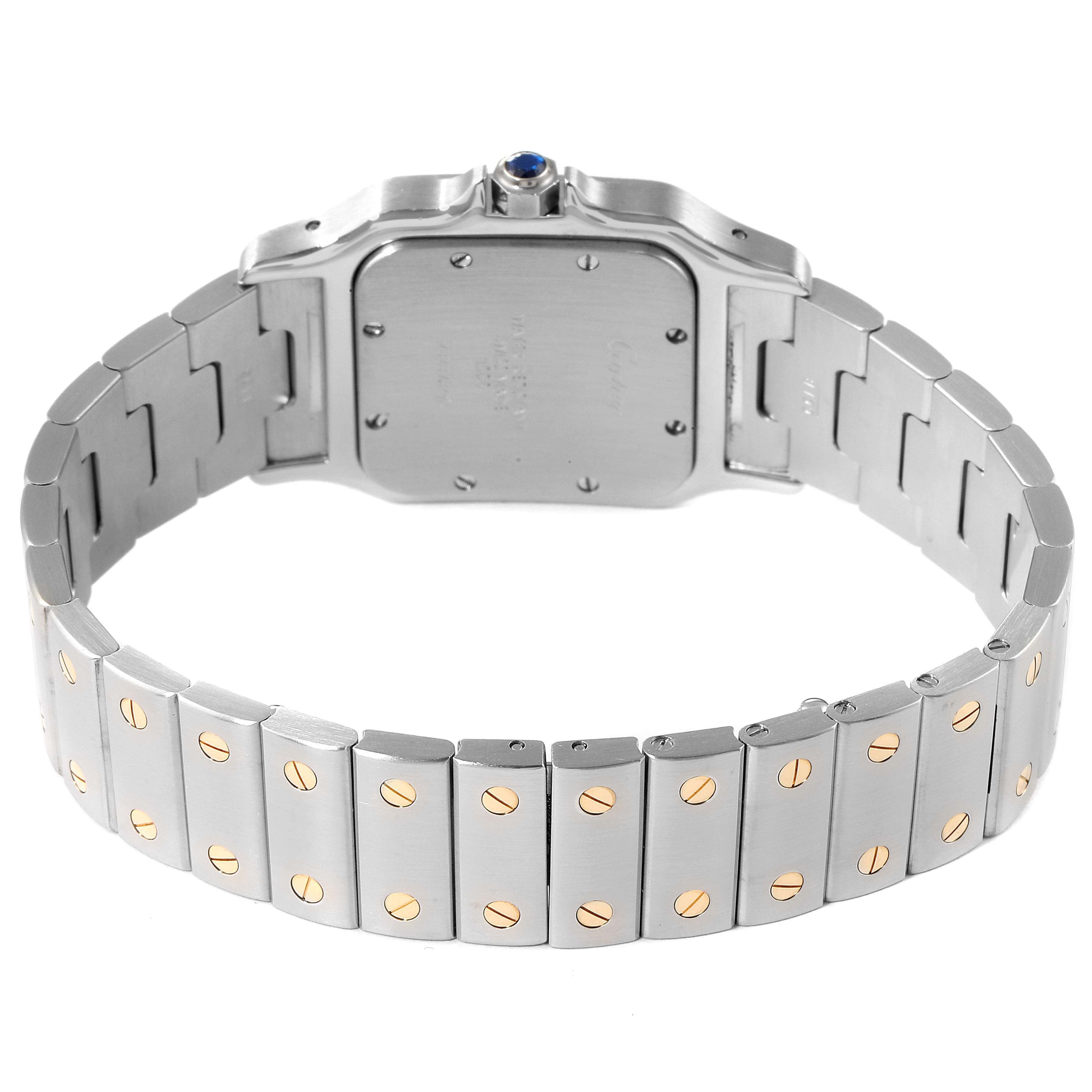 The image shows a rear view of the Cartier Santos W20011C4 Men
s Steel and Gold (two tone) Silver Dial W20011C4 Men
s Steel and Gold (two tone) Silver Dial watch, focusing on the case back and metal bracelet with gold screw details.