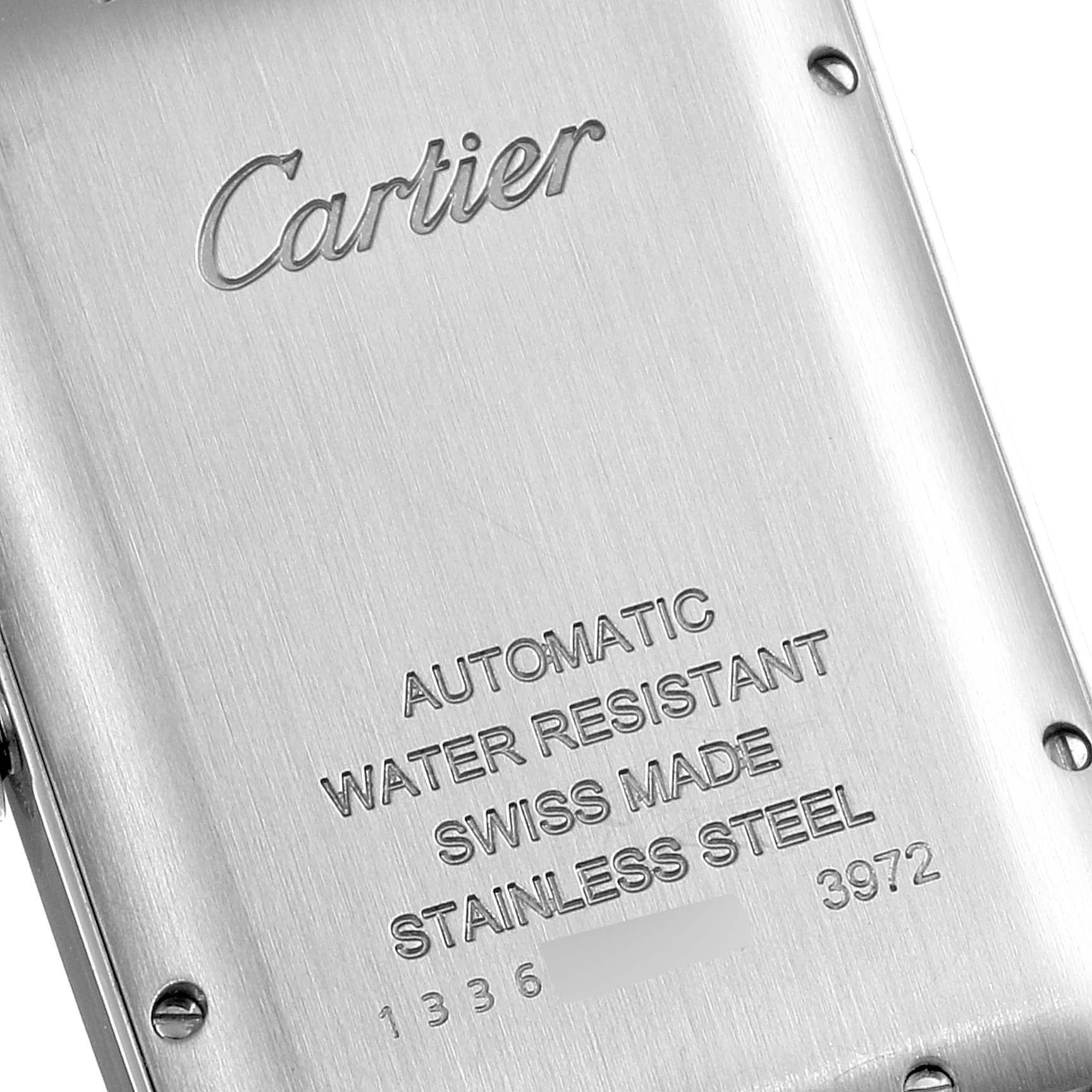 This image shows the back of a Cartier Tank Americaine WSTA0018 Men
s Stainless Steel Silver Dial WSTA0018 Men
s Stainless Steel Silver Dial watch, highlighting engravings indicating materials and specifications.