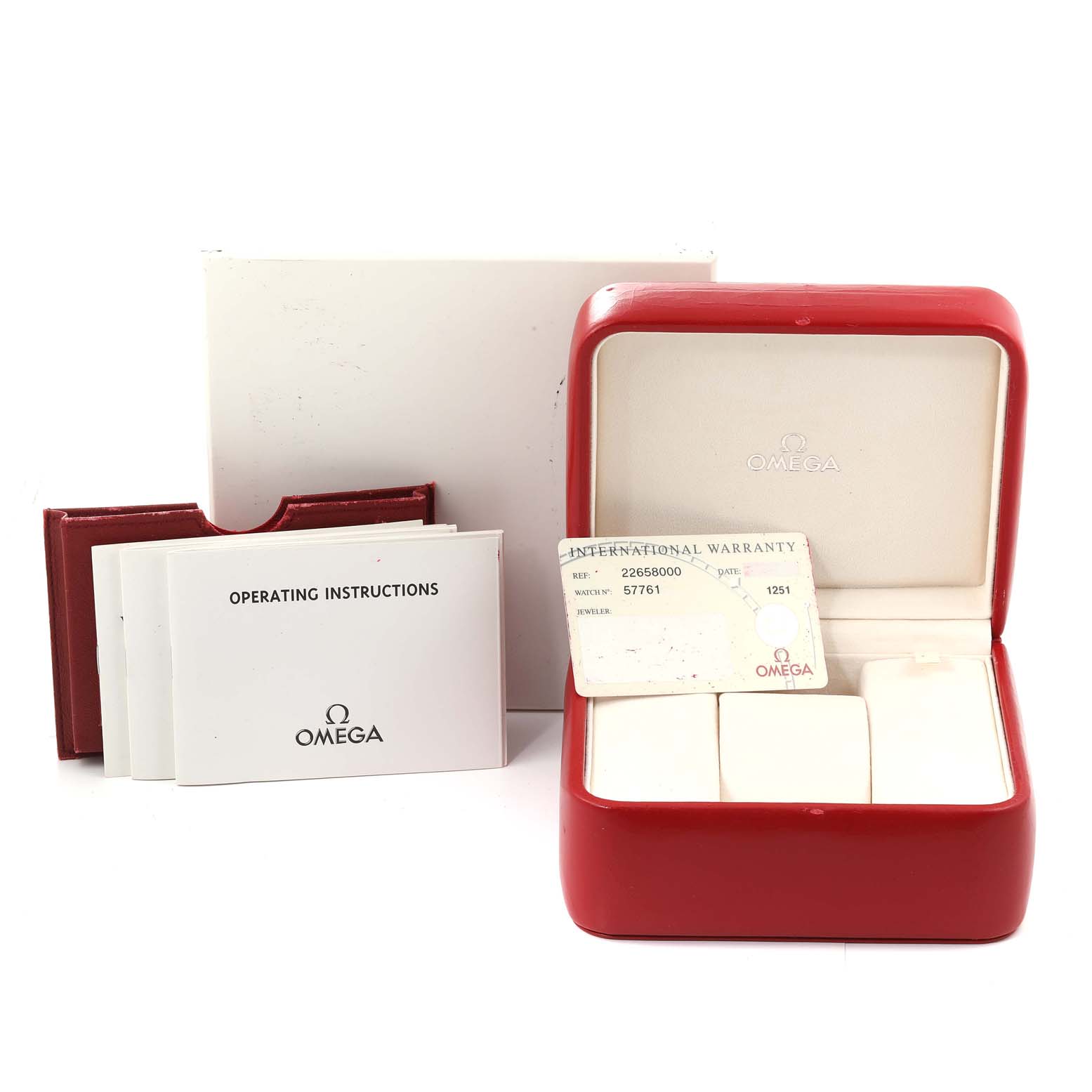 The image shows the accessories for the Omega Seamaster 2265.80.00 Men's Stainless Steel Blue Dial 2265.80.00 Men's Stainless Steel Blue Dial model, including its red case, operating instructions, and warranty card.