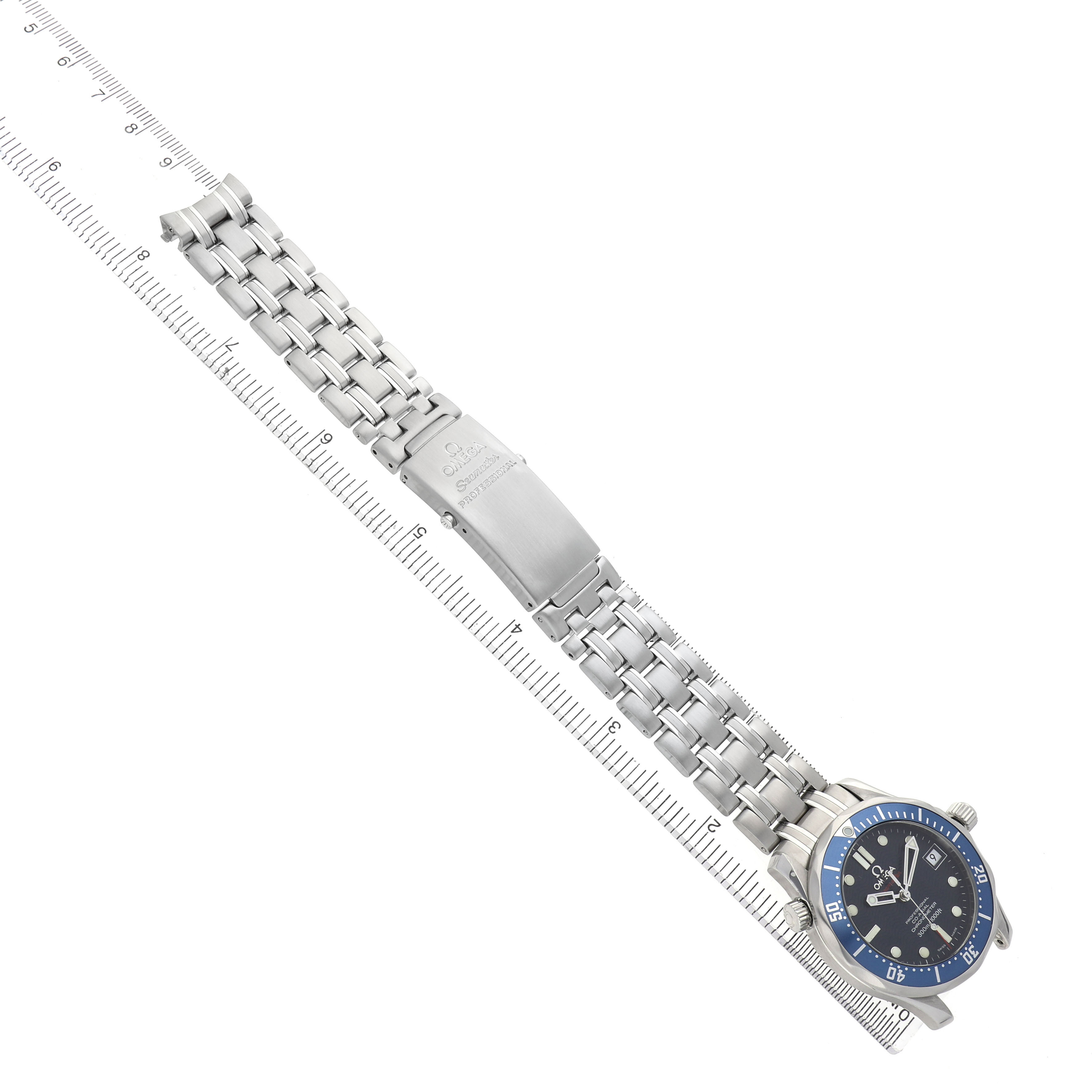 The Omega Seamaster 2222.80.00 Men's Stainless Steel Blue Dial watch is shown from an angled top view, featuring its face and full metal bracelet by a ruler.