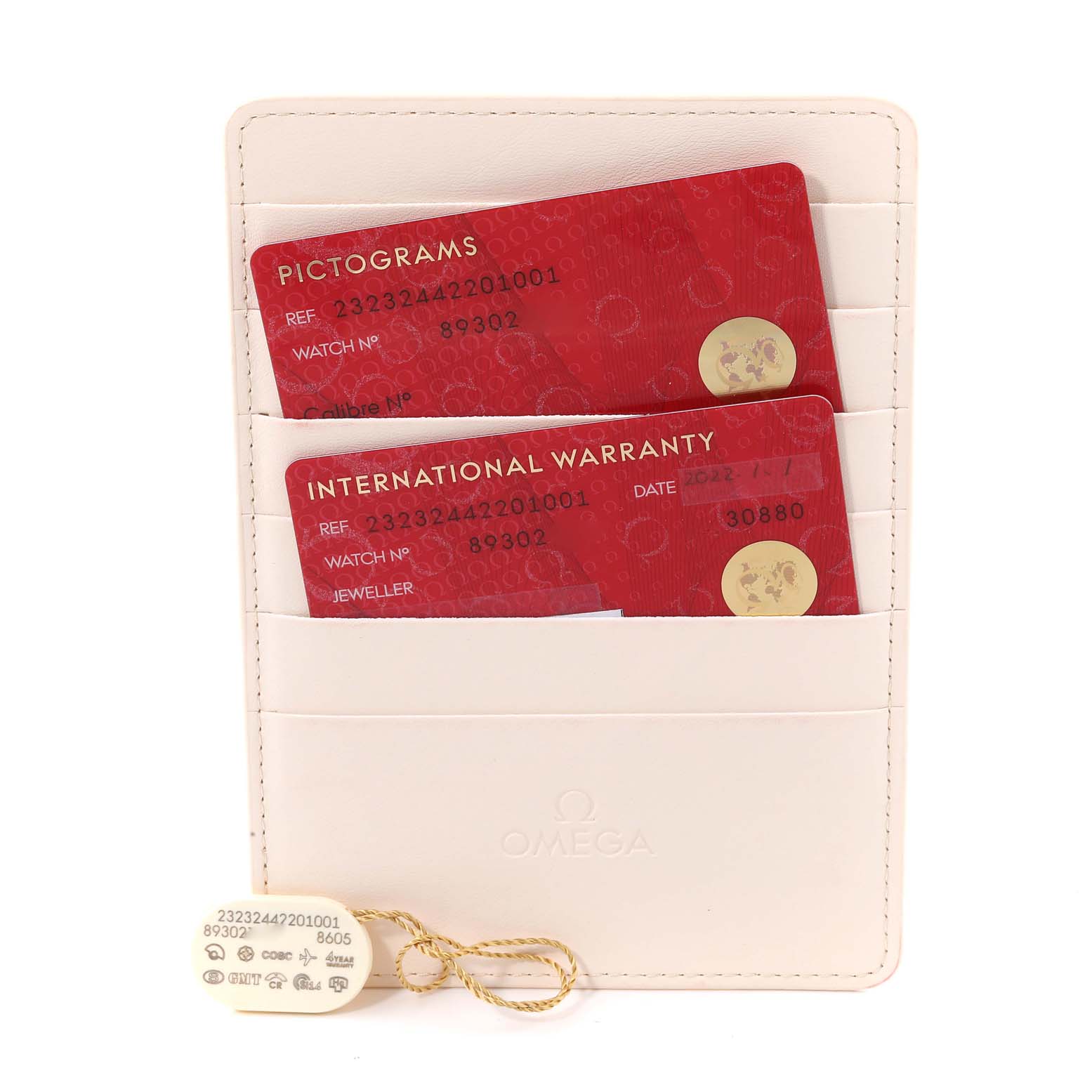 The image shows the international warranty and pictograms cards along with tags for the Omega Planet Ocean 232.32.44.22.01.001 Men
s Stainless Steel Black Dial 232.32.44.22.01.001 Men
s Stainless Steel Black Dial model, presented in a white holder.