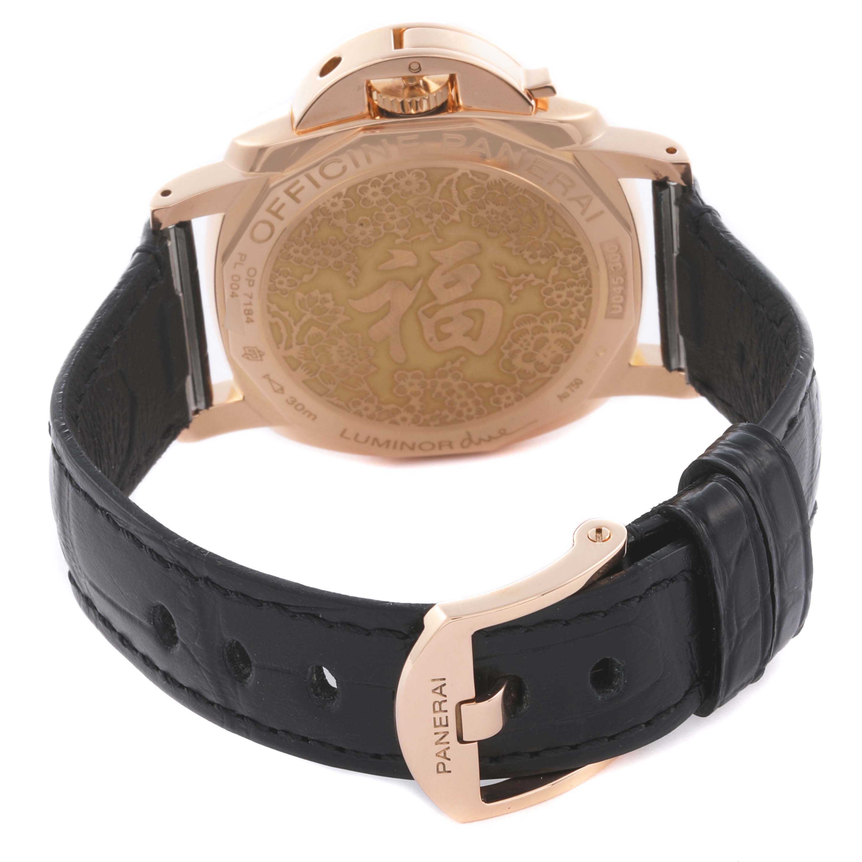 The image shows the back of a Panerai Luminor PAM00908 Men's Rose Gold Black Dial PAM00908 Men's Rose Gold Black Dial watch, featuring its case back engraving and black leather strap.