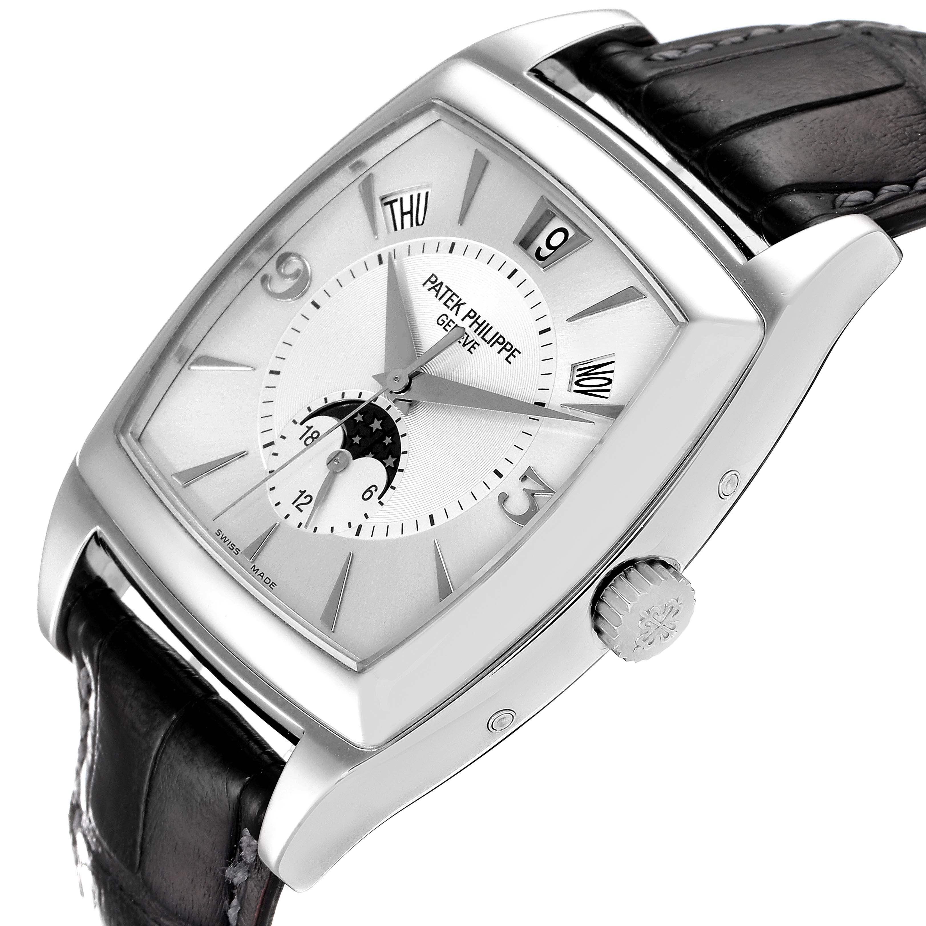 This image shows a Patek Philippe Gondolo 5135G Men's White Gold Silver Dial 5135G Men's White Gold Silver Dial watch at an angle, highlighting its dial, crown, and leather strap.