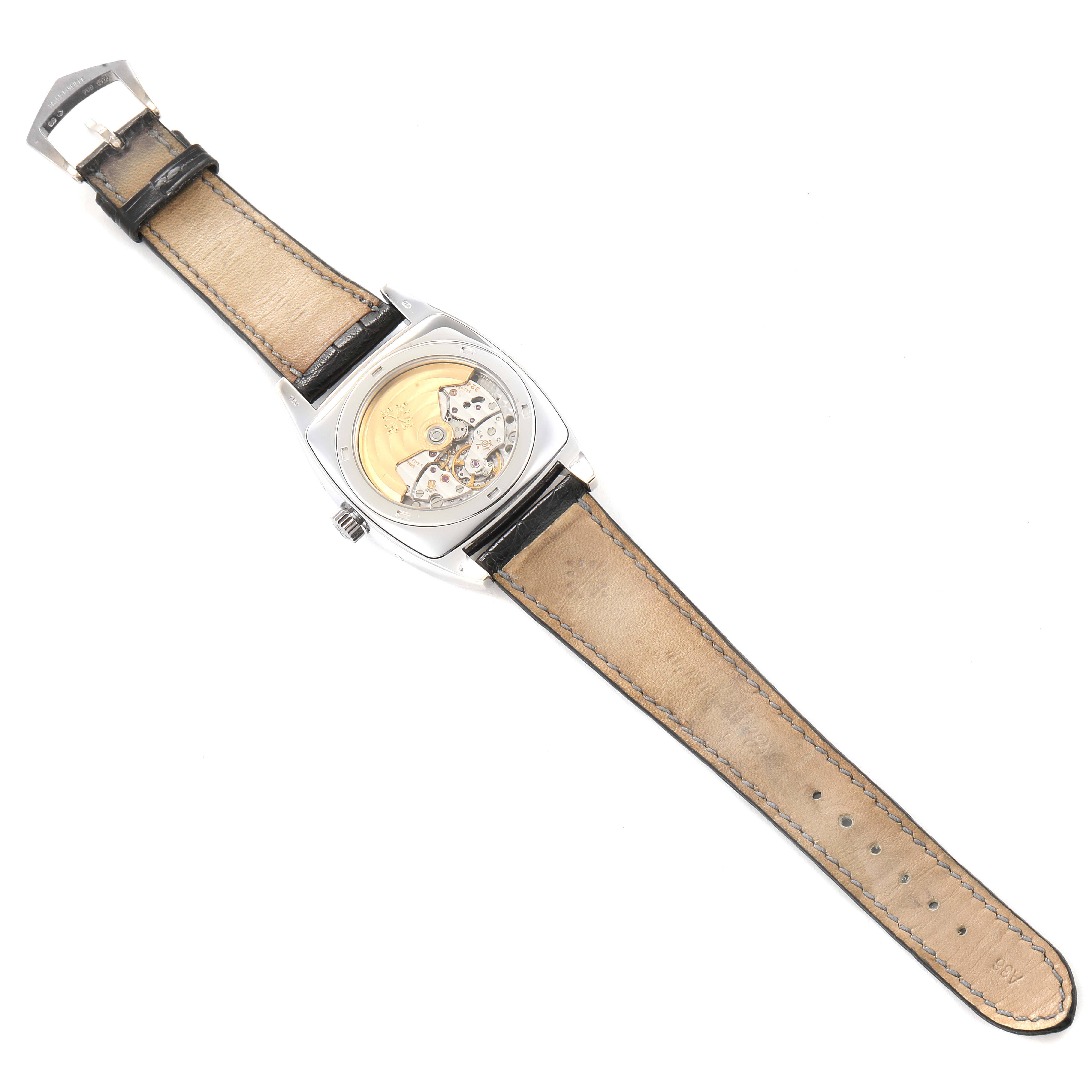 The image shows the back of a Patek Philippe Gondolo 5135G Men's White Gold Silver Dial 5135G Men's White Gold Silver Dial watch, highlighting the movement mechanism and the leather strap.