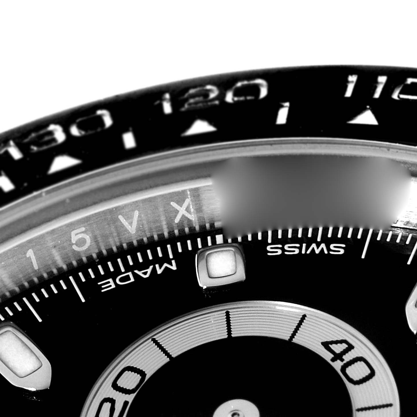 The image shows a close-up of the dial and bezel of a Rolex Daytona 116500 Men's Stainless Steel Black Dial 116500 Men's Stainless Steel Black Dial watch, highlighting the tachymeter scale and partial sub-dial.
