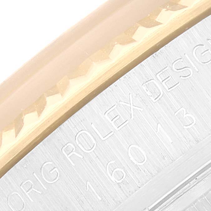 The image shows an angled close-up of the engraved edge and bezel of the Vintage Collection model by Rolex.