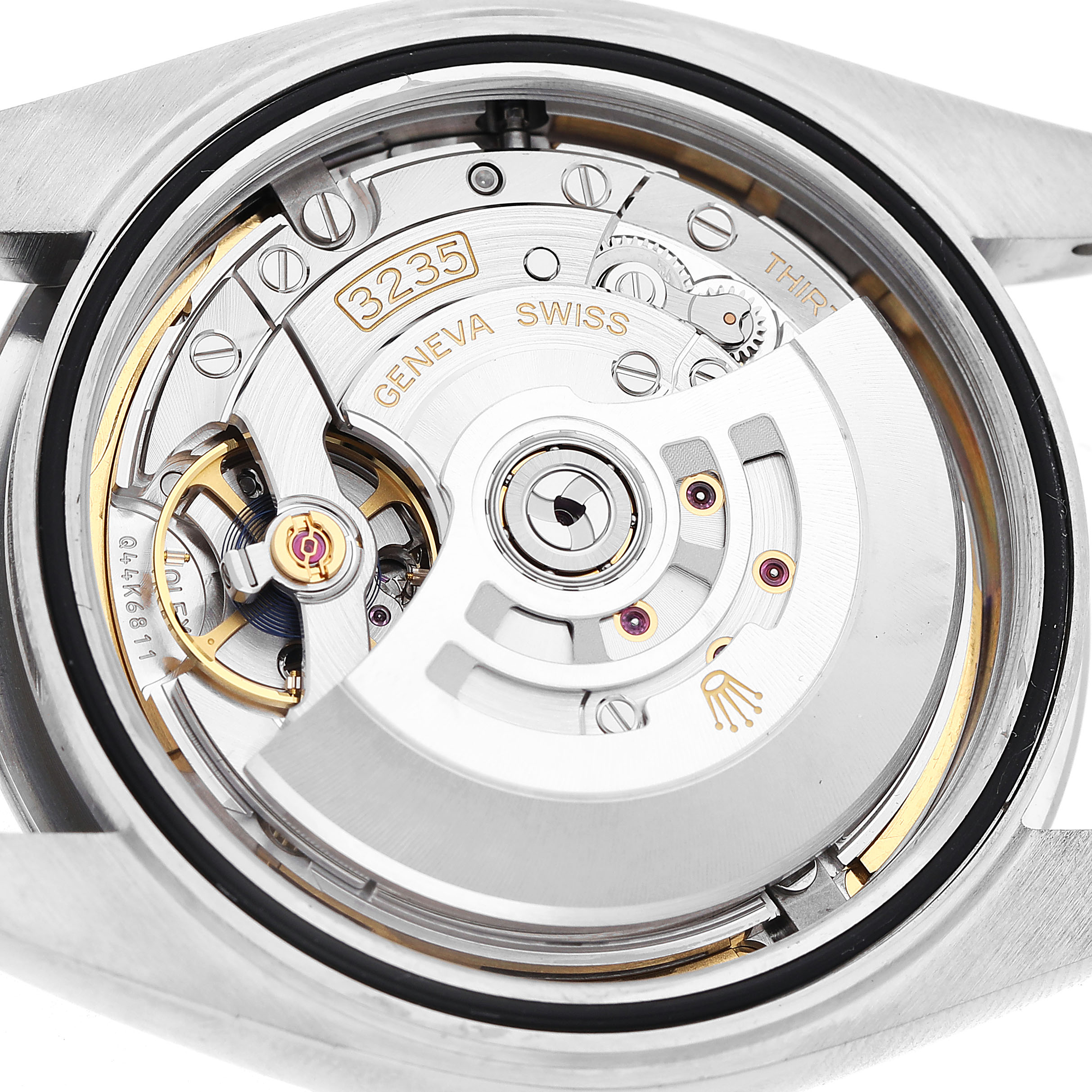 The image shows the movement of a Rolex Datejust 41 126300 Men's Stainless Steel Blue Dial, highlighting its intricate mechanics and rotor from the back.