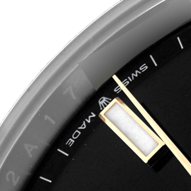 The image shows a close-up of a Rolex Datejust's dial, specifically the "Swiss Made" text, part of the bezel, and indices.