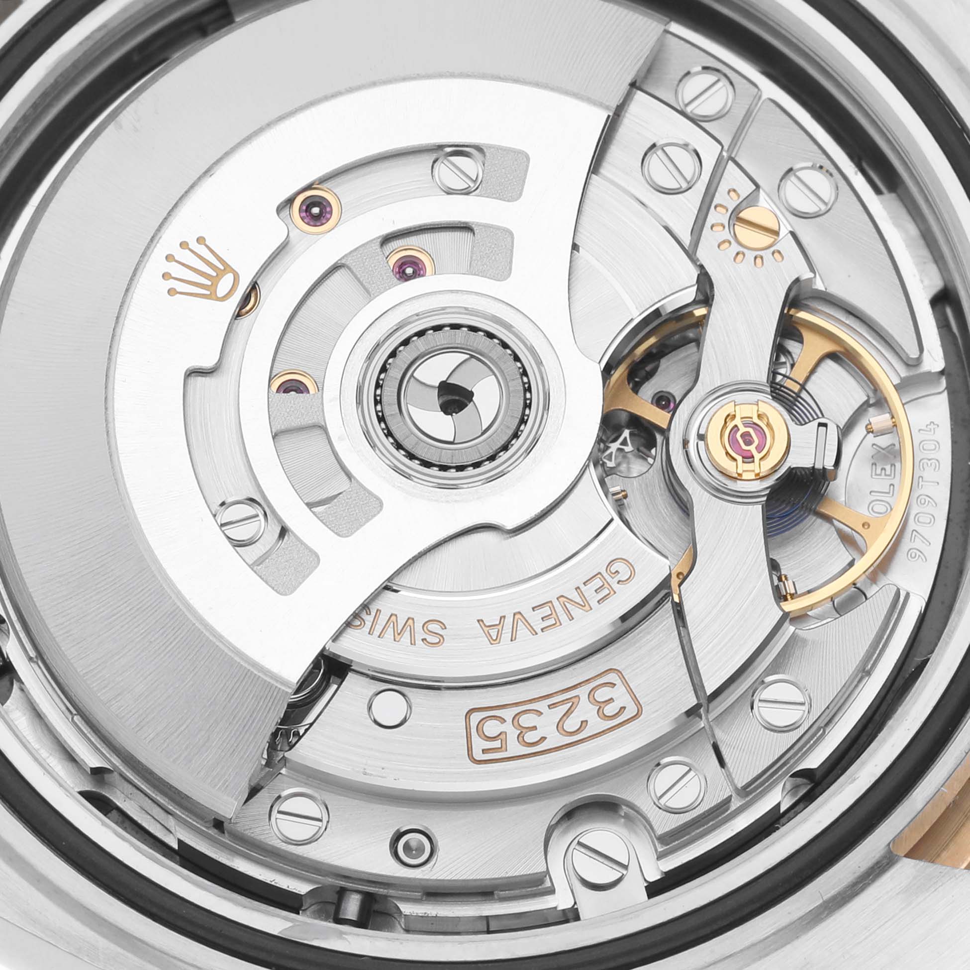 The image shows a close-up of the Rolex Datejust movement, focusing on the rotor and intricate mechanics.