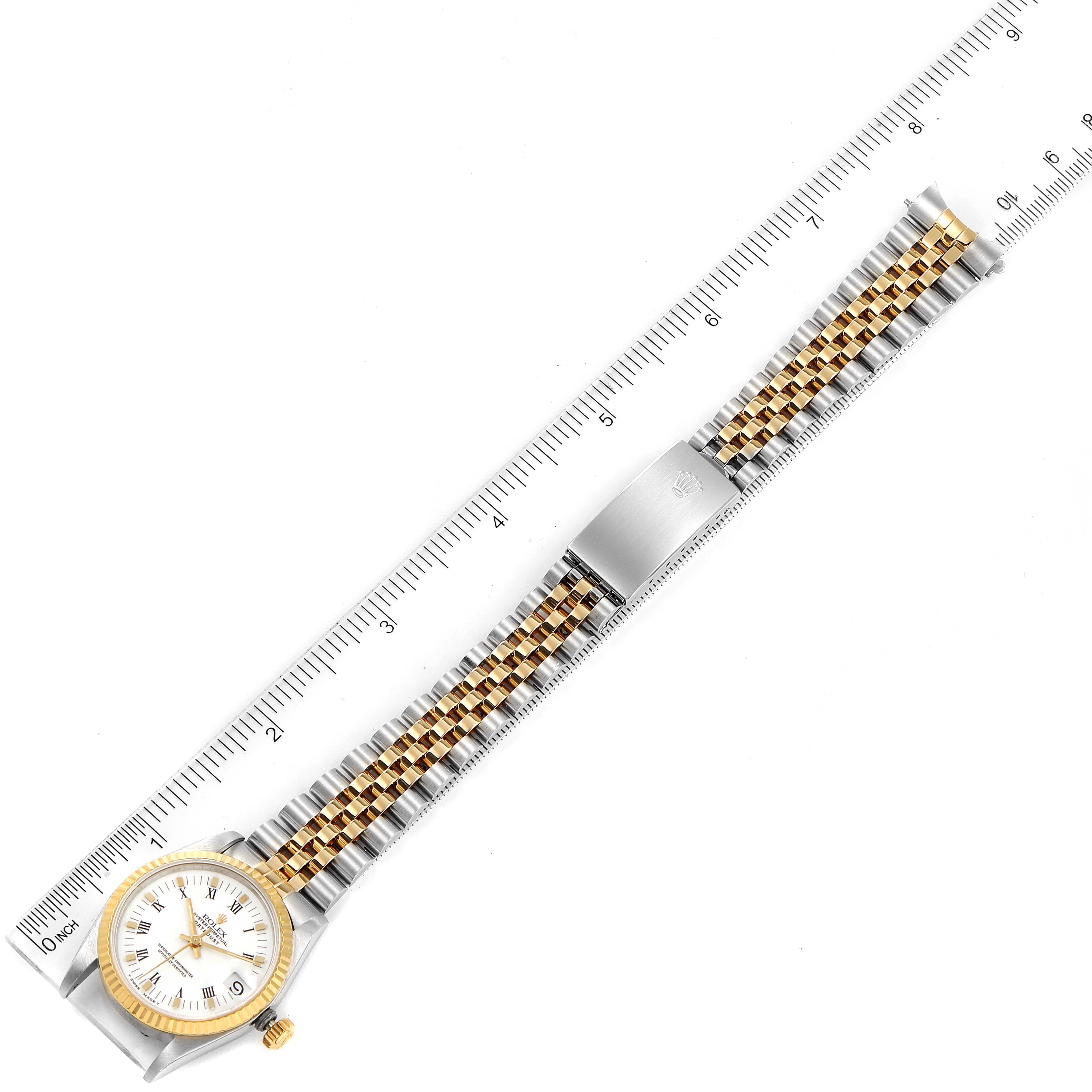 The Rolex Mid-Size 68273 Women's Steel and Gold (two tone) White Dial 68273 Women's Steel and Gold (two tone) White Dial watch is shown top-down, displaying the case, bracelet, clasp, and a ruler for scale.