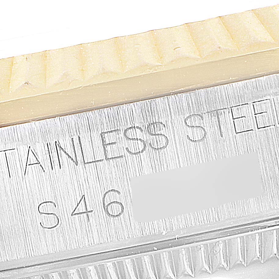 The image shows a close-up view of the side of a stainless steel Rolex Mid-Size 68273 Women's Steel and Gold (two tone) White Dial 68273 Women's Steel and Gold (two tone) White Dial watch, highlighting the serial number and part of the bezel.