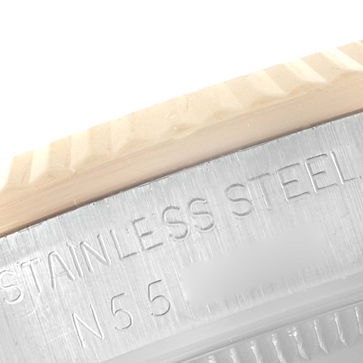 This close-up shows the side bezel and the case back edge of a Rolex Mid-Size 68273 Women's Steel and Gold (two tone) White Dial 68273 Women's Steel and Gold (two tone) White Dial model, highlighting "STAINLESS STEEL" engravings.