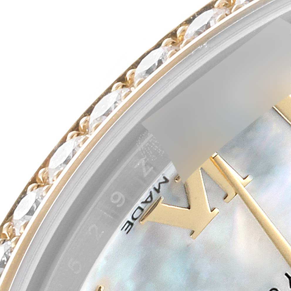 This close-up image shows the bezel and part of the dial of a Mid-Size Rolex watch with a diamond-studded edge and gold Roman numeral.
