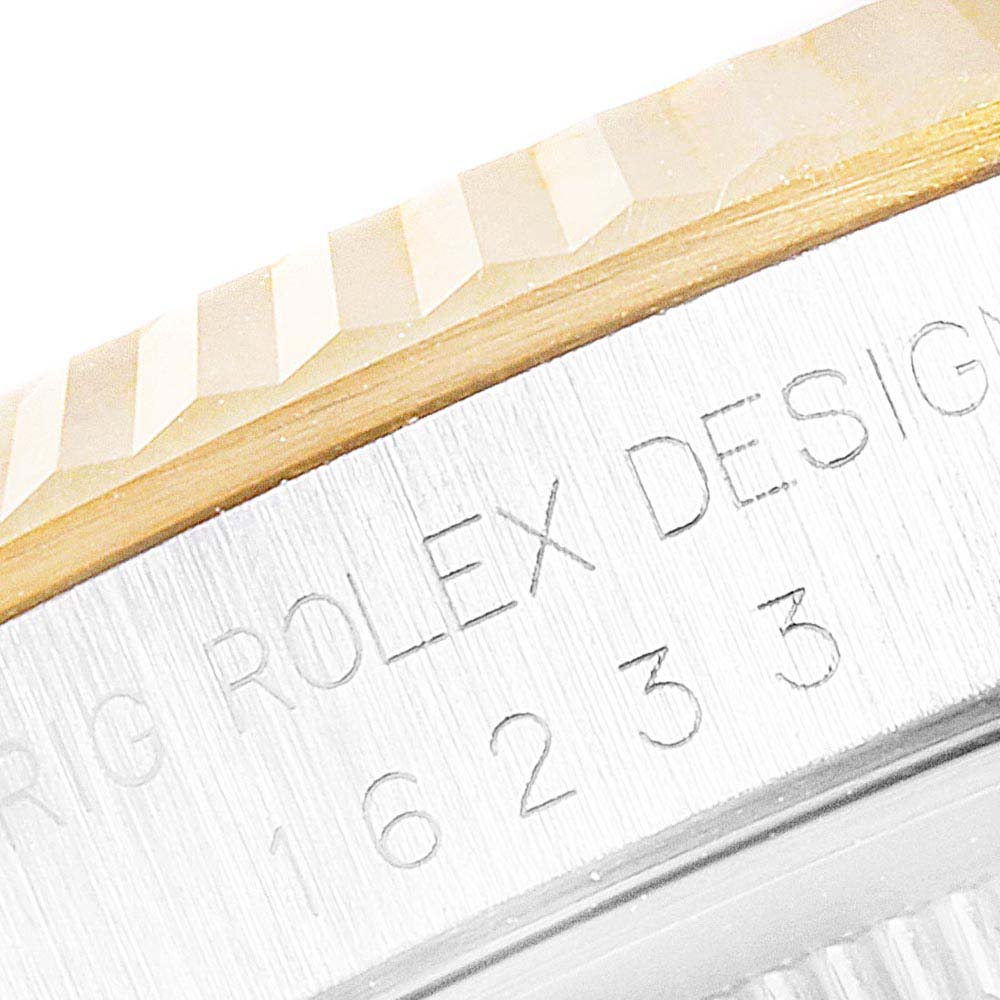 This image shows a close-up angle of the bezel and engraved case side of a Rolex Datejust 16233 Men's Steel and Gold (two tone) Champagne Dial 16233 Men's Steel and Gold (two tone) Champagne Dial.
