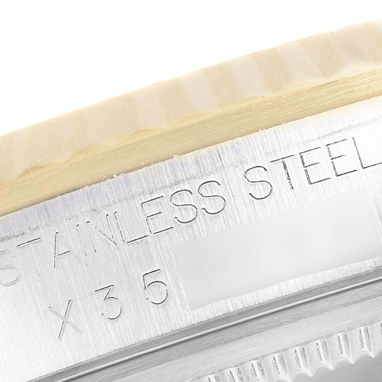 This close-up image shows the engraved caseback of the Rolex Datejust 16233 Men's Steel and Gold (two tone) Champagne Dial 16233 Men's Steel and Gold (two tone) Champagne Dial watch, focusing on the stainless steel markings.