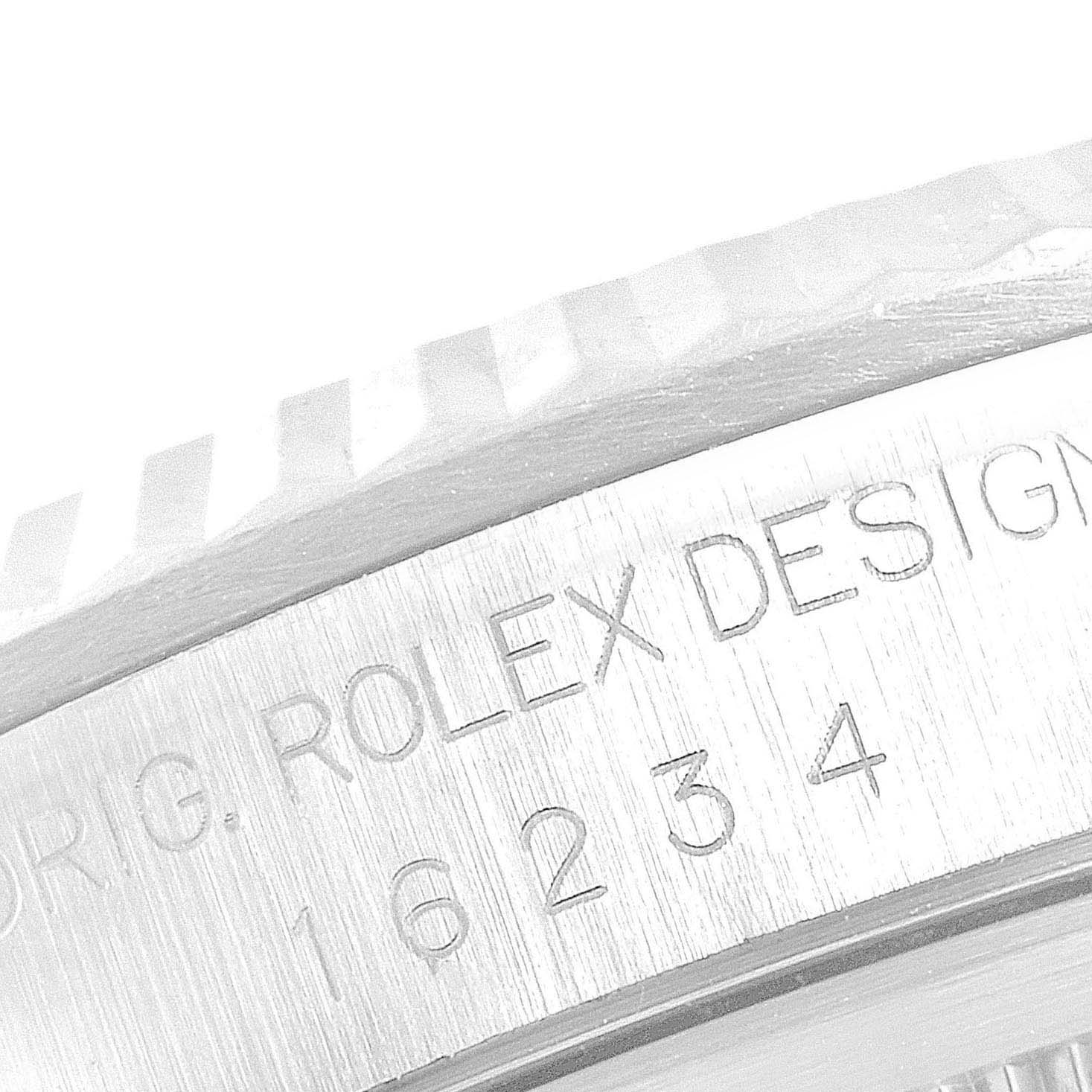 This image shows a close-up of the side engraving on the bezel of a Rolex Datejust 16234 Men's Stainless Steel Silver Dial 16234 Men's Stainless Steel Silver Dial model.