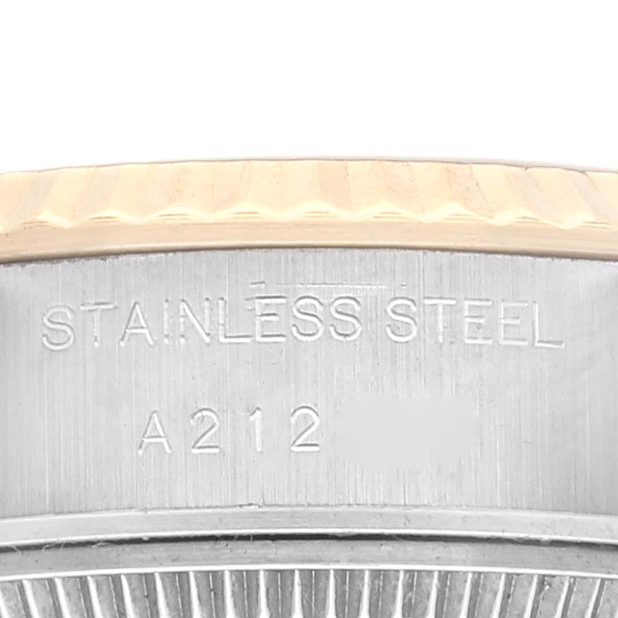 This close-up image shows the side of the Rolex Datejust 79173 Women's Steel and Gold (two tone) Champagne Dial 79173 Women's Steel and Gold (two tone) Champagne Dial watch model, highlighting the stainless steel body and text engraving.
