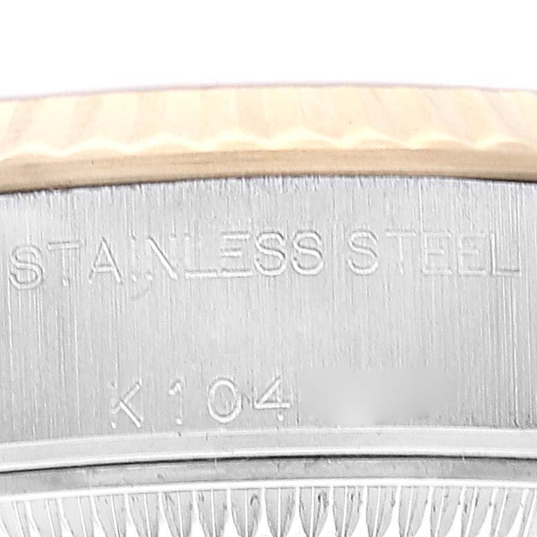 This image shows a close-up of the stainless steel caseback engraving and the fluted bezel of the Rolex Datejust 79173 Women's Steel and Gold (two tone) Champagne Dial 79173 Women's Steel and Gold (two tone) Champagne Dial watch.
