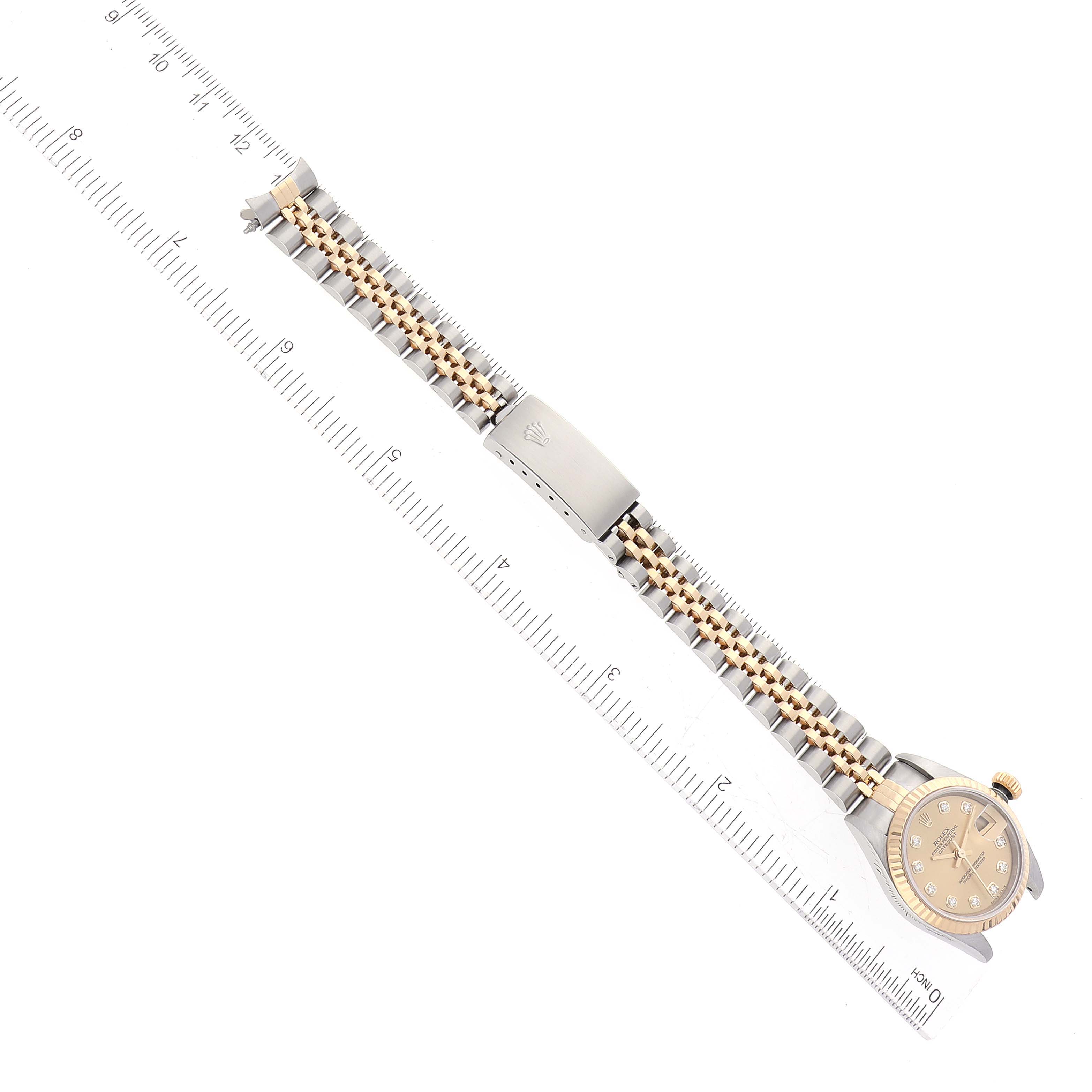 The image shows a top-down view of a Rolex Datejust 79173 Women's Steel and Gold (two tone) Champagne Dial 79173 Women's Steel and Gold (two tone) Champagne Dial watch, highlighting the watch face, bracelet, and clasp.