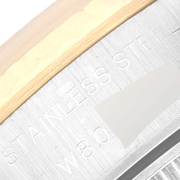 The image shows a close-up of the bezel edge of a Rolex Datejust 69173 Women's Steel and Gold (two tone) White Dial 69173 Women's Steel and Gold (two tone) White Dial watch, highlighting the stainless steel and gold finish.