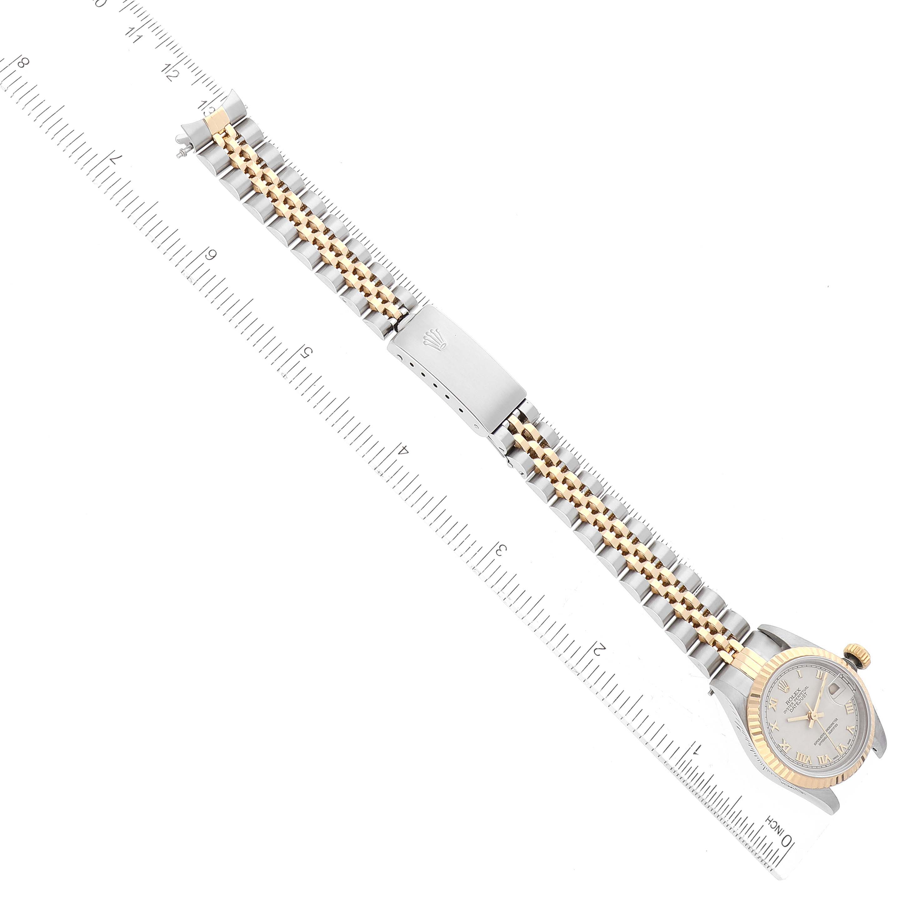 The image shows an overhead view of a Rolex Datejust 69173 Women's Steel and Gold (two tone) White Dial 69173 Women's Steel and Gold (two tone) White Dial watch, including its case, dial, bracelet, and clasp.
