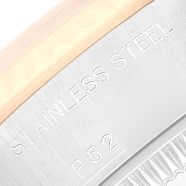 Close-up shot of the Rolex Datejust 79173 Women
s Steel and Gold (two tone) Red Dial 79173 Women
s Steel and Gold (two tone) Red Dial watch showing the stainless steel and gold edge with part of the serial number.