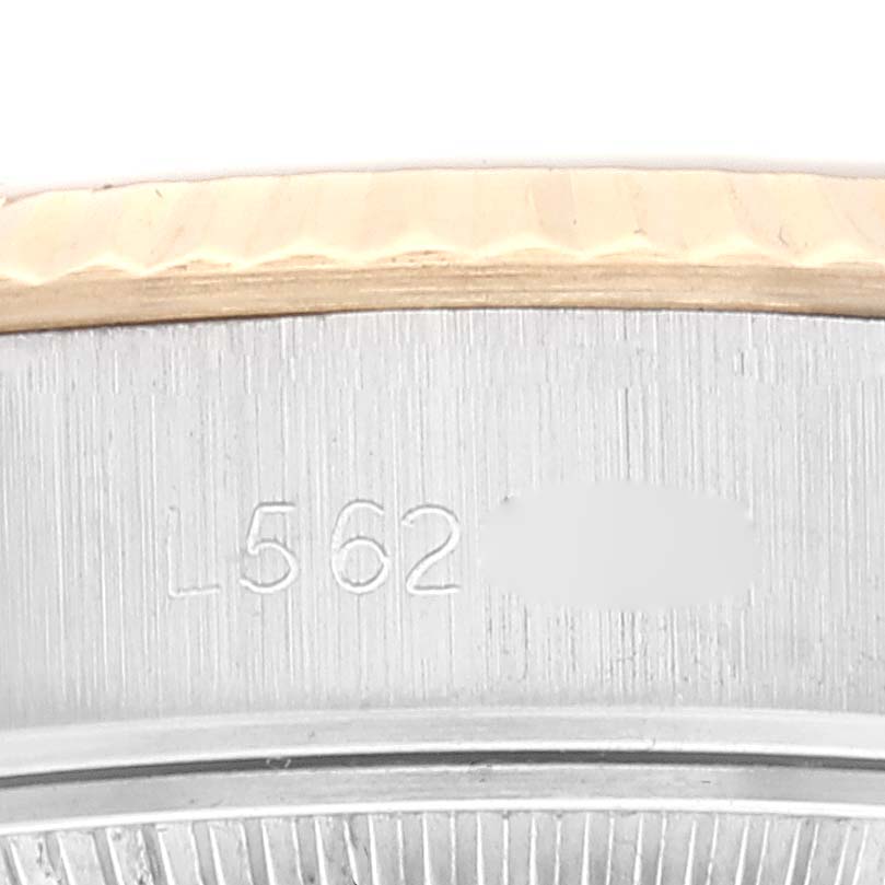 The image shows a close-up of the casing and engraved serial number of a Rolex Datejust 69173 Women's Steel and Gold (two tone) White Dial 69173 Women's Steel and Gold (two tone) White Dial watch.