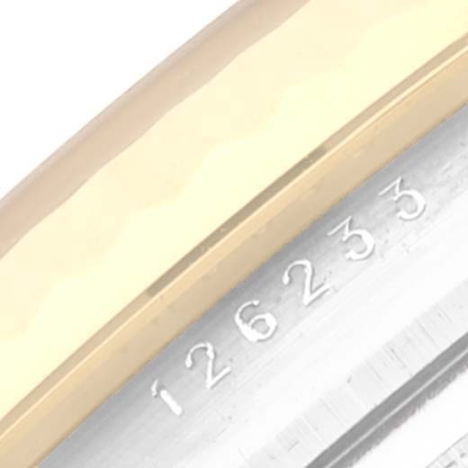 The image shows a close-up of the serial number on the case of a Rolex Datejust 126233 Men's Steel and Gold (two tone) White Dial 126233 Men's Steel and Gold (two tone) White Dial watch, model 126233.